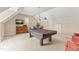 Game room with neutral walls and carpet features a pool table, TV, and seating, perfect for entertaining guests at 2000 Silverleaf Dr, Youngsville, NC 27596