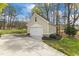 Exterior of detached garage with a driveway and simple landscaping at 2000 Silverleaf Dr, Youngsville, NC 27596