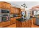 Kitchen with wood cabinets, granite counters, stainless steel appliances, island, and hardwood floors at 2000 Silverleaf Dr, Youngsville, NC 27596