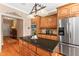 Kitchen island with wood cabinets, granite counters, stainless steel appliances, and hardwood floors at 2000 Silverleaf Dr, Youngsville, NC 27596