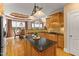 Eat in kitchen with stone countertops and backsplash, island, custom cabinetry, and stainless steel appliances at 2000 Silverleaf Dr, Youngsville, NC 27596