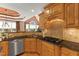 A spacious kitchen with wood cabinets, granite counters, stainless steel appliances, and a tile backsplash at 2000 Silverleaf Dr, Youngsville, NC 27596