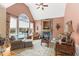 Comfortable living room featuring a stone fireplace, vaulted ceiling, and backyard pool view at 2000 Silverleaf Dr, Youngsville, NC 27596