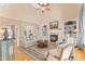 Bright living room features hardwood floors, a fireplace, and elegant decor with views into the dining area at 2000 Silverleaf Dr, Youngsville, NC 27596