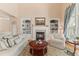 Cozy living room with built-in bookshelves, plush seating, and a warm fireplace at 2000 Silverleaf Dr, Youngsville, NC 27596