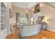 Spacious living room featuring hardwood floors, a fireplace, and large windows offering scenic views at 2000 Silverleaf Dr, Youngsville, NC 27596