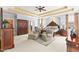 Main bedroom with decorative ceiling, carpet, sitting area, bed, and dark-wood furniture at 2000 Silverleaf Dr, Youngsville, NC 27596