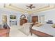 Spacious main bedroom featuring decorative ceiling, carpet, dark-wood furniture, and sitting area at 2000 Silverleaf Dr, Youngsville, NC 27596