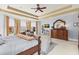 Spacious main bedroom with decorative ceiling, carpet, bed, sitting area, and dark-wood furniture at 2000 Silverleaf Dr, Youngsville, NC 27596