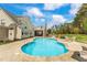 Backyard with a pool, patio furniture, and large windows on the home at 2000 Silverleaf Dr, Youngsville, NC 27596