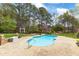 Beautiful backyard pool surrounded by lush landscaping and mature trees, creating a private oasis at 2000 Silverleaf Dr, Youngsville, NC 27596