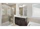 Beautiful bathroom featuring a tiled glass shower, soaking tub and vanity with a large mirror at 204 Concordia Woods Dr, Morrisville, NC 27560