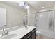Bright bathroom with double sink vanity, large mirror, and a shower/tub combo with tile surround at 204 Concordia Woods Dr, Morrisville, NC 27560