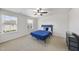 Inviting bedroom with neutral carpet, blue accent bedding, and ample natural light from the two windows at 204 Concordia Woods Dr, Morrisville, NC 27560