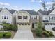 Charming two-story home featuring a stone facade, red shutters, and a well-maintained front yard at 204 Concordia Woods Dr, Morrisville, NC 27560