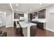 Modern kitchen with dark cabinets, quartz countertops, stainless steel appliances, and a kitchen island at 204 Concordia Woods Dr, Morrisville, NC 27560