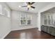 Well lit living area showcasing large windows, hardwood floors, and open space for versatile furniture arrangement at 204 Concordia Woods Dr, Morrisville, NC 27560