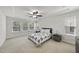 Bright main bedroom with multiple windows, a ceiling fan and neutral décor at 204 Concordia Woods Dr, Morrisville, NC 27560