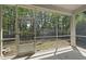 Screened porch offering a relaxing outdoor space overlooking the backyard with mature trees at 204 Concordia Woods Dr, Morrisville, NC 27560