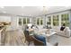 Spacious living room featuring a comfortable sofa, dining area, and natural light streaming through many windows at 211 Faith Ave, Sanford, NC 27330