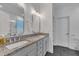 Bathroom boasts a dual-sink vanity with stone countertop and modern fixtures at 212 Hein Dr, Clayton, NC 27527