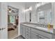 Bright bathroom featuring a double vanity, granite countertop, and a separate glass-enclosed shower and toilet at 212 Hein Dr, Clayton, NC 27527