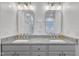 Bathroom features a dual-sink vanity with stone countertop and modern lighting at 212 Hein Dr, Clayton, NC 27527