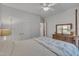 Cozy bedroom with carpet, ceiling fan, and a traditional wooden dresser with mirror at 212 Hein Dr, Clayton, NC 27527