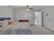 Bright bedroom showcasing neutral carpet, a striped bedspread, and two white doors at 212 Hein Dr, Clayton, NC 27527