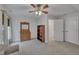 Cozy bedroom with gray carpet, dresser, bookshelf, ceiling fan, and two doors at 212 Hein Dr, Clayton, NC 27527