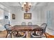 Formal dining room featuring wainscoting, a chandelier, and hardwood floors at 212 Hein Dr, Clayton, NC 27527