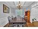 Formal dining room featuring wainscoting, a chandelier, and hardwood floors at 212 Hein Dr, Clayton, NC 27527