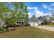 Charming home with a welcoming front porch, attached two-car garage, and well-manicured lawn at 212 Hein Dr, Clayton, NC 27527