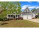 Charming home with a welcoming front porch, attached two-car garage, and well-manicured lawn at 212 Hein Dr, Clayton, NC 27527