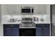 Bright kitchen with stainless steel appliances and stylish two-toned cabinetry at 212 Hein Dr, Clayton, NC 27527