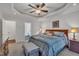 Main bedroom with a tray ceiling, ceiling fan and access to the adjoining bathroom at 212 Hein Dr, Clayton, NC 27527