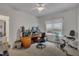 Office space with ceiling fan, desk with computer setup, and exercise equipment at 212 Hein Dr, Clayton, NC 27527