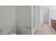 This bathroom is complete with a toilet, brown cabinets, a tile floor and a glass door shower at 2214 Bayswater Dr, Creedmoor, NC 27522