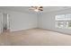 A spacious bedroom is showcased with beige walls, carpeted floors, and a ceiling fan for comfort at 2214 Bayswater Dr, Creedmoor, NC 27522