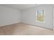Bedroom featuring neutral carpet, white walls, and a window at 2214 Bayswater Dr, Creedmoor, NC 27522