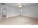 Spacious bedroom with neutral walls, plush carpet, ceiling fan, and adjacent bathroom for convenience at 2214 Bayswater Dr, Creedmoor, NC 27522
