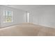 This bedroom features neutral walls, plush carpet and a large window for natural light at 2214 Bayswater Dr, Creedmoor, NC 27522