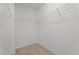 Spacious walk-in closet has carpeted floors and provides shelving with wire racks for organized storage at 2214 Bayswater Dr, Creedmoor, NC 27522