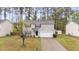 Charming two-story home featuring a well-maintained lawn, attached garage, and mature trees providing shade at 2214 Bayswater Dr, Creedmoor, NC 27522