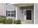 Inviting front door of the residence, complemented by a manicured garden and freshly painted column at 2214 Bayswater Dr, Creedmoor, NC 27522