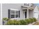 Close-up of the front entrance showcases the black door, window, and manicured landscaping at 2214 Bayswater Dr, Creedmoor, NC 27522