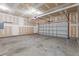 Spacious garage featuring a large door for vehicle parking, still in the finishing process at 2214 Bayswater Dr, Creedmoor, NC 27522