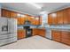 Modern kitchen featuring stainless steel appliances, granite countertops, and wooden cabinets at 2214 Bayswater Dr, Creedmoor, NC 27522