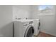 Bright laundry area featuring a washer and dryer with a window and wire shelf for extra storage at 2214 Bayswater Dr, Creedmoor, NC 27522