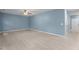 Bright living room boasts light-colored wood floors, blue walls, and a ceiling fan at 2214 Bayswater Dr, Creedmoor, NC 27522